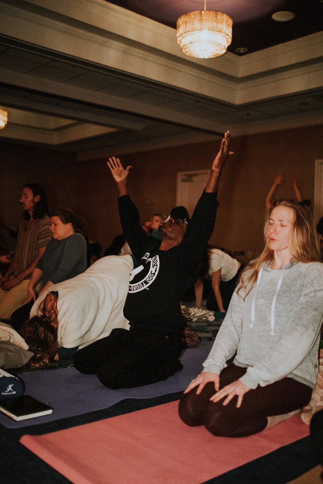 A man with arms raised during a group activation