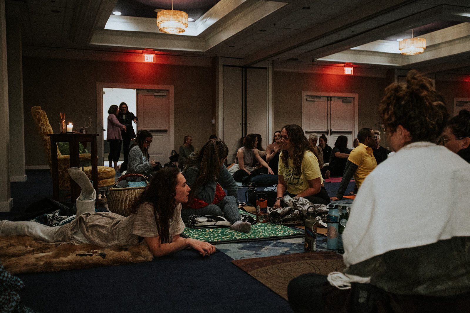 People relaxed together in a candlelit corner of the room
