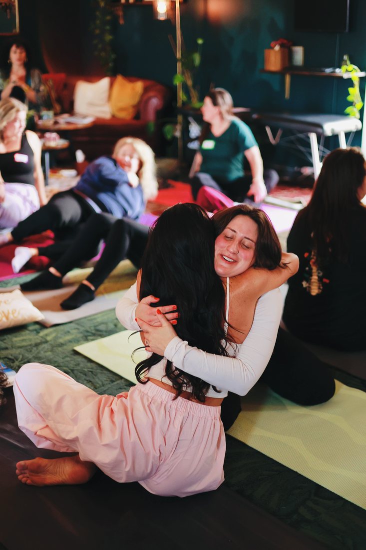 Two women hugging warmly during a past gathering
