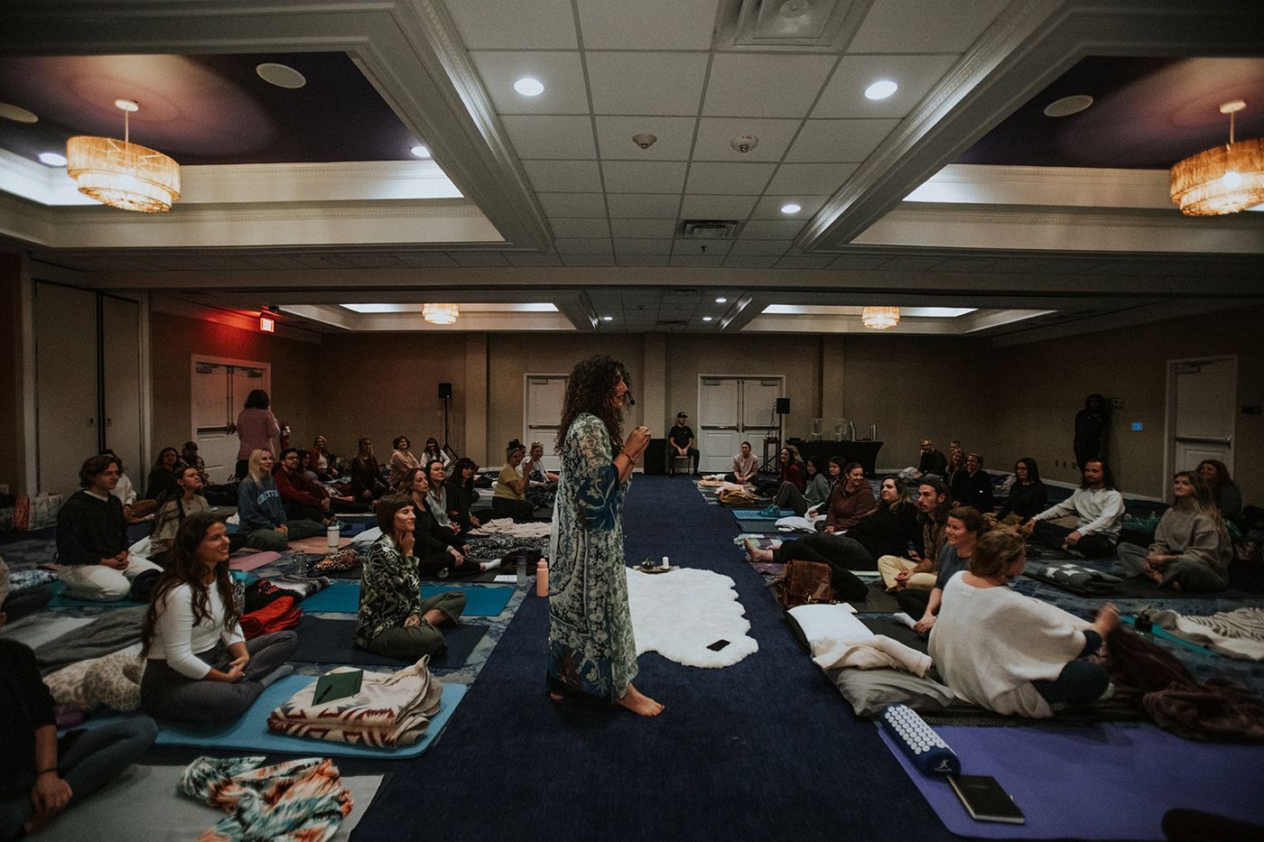 Dr. Kate Glebocki teaching a full room during a past gathering